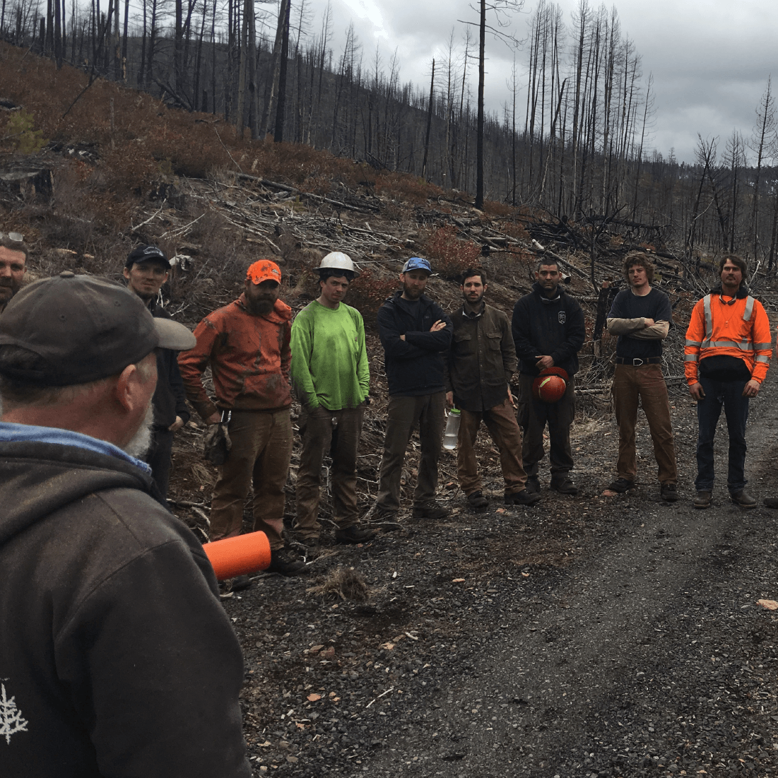 Group gathers for discussion during the advanced tree-cutting workshop.